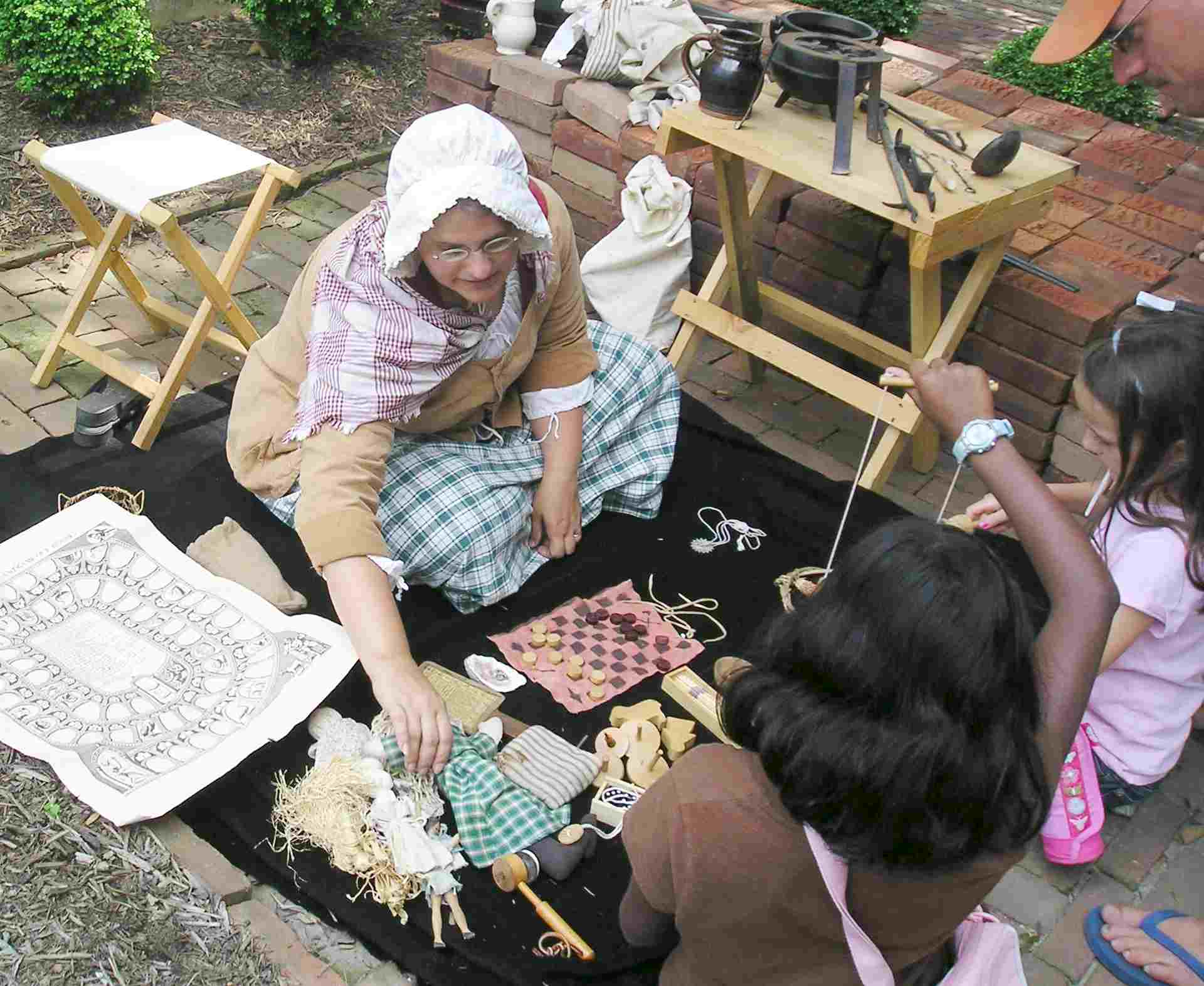 Pam Shipman shows visitors a variety of 18th century toys.