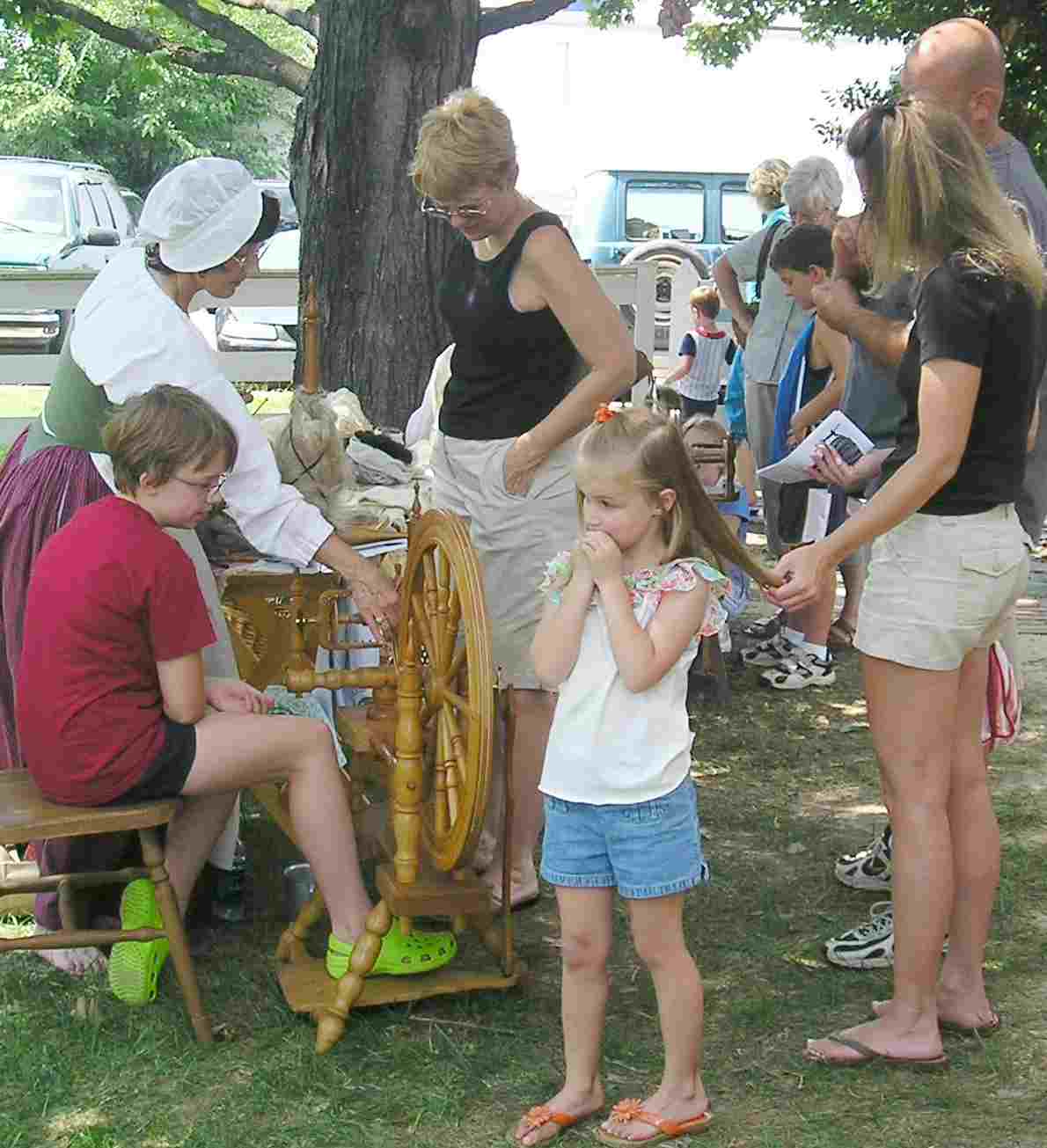 Susan Robbins show visitors how
 18th century housewives carded and spun wool
  into yarn and flax into thread.